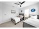 This bedroom features two beds, a ceiling fan, and light gray colored walls with white trim at 422 Islebay Dr, Apollo Beach, FL 33572
