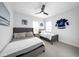 This bedroom features two beds, ceiling fan, and a Tampa Bay Lightning team logo and jersey at 422 Islebay Dr, Apollo Beach, FL 33572