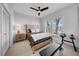 Modern bedroom with neutral walls, a ceiling fan, and light colored carpet flooring at 422 Islebay Dr, Apollo Beach, FL 33572