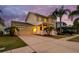 Two-story single Gathering home with a charming front porch, well-manicured lawn, and attached garage at 422 Islebay Dr, Apollo Beach, FL 33572