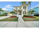 Inviting two-story home with a welcoming front porch, lush landscaping, and a charming facade at 422 Islebay Dr, Apollo Beach, FL 33572