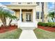 Charming front porch featuring classic columns, wood ceiling, and comfortable seating area at 422 Islebay Dr, Apollo Beach, FL 33572