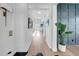 Elegant hallway with hardwood floors, a modern accent wall, and stylish decor elements at 422 Islebay Dr, Apollo Beach, FL 33572