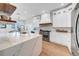 Well-lit kitchen featuring an island with seating, modern appliances, and ample white cabinetry at 422 Islebay Dr, Apollo Beach, FL 33572