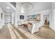 Sun-filled living room with vaulted ceiling, hardwood floors, comfortable seating, and a view of the front door at 422 Islebay Dr, Apollo Beach, FL 33572