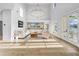 Bright living room featuring hardwood floors, modern chandelier, and doors to the outside at 422 Islebay Dr, Apollo Beach, FL 33572