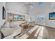 Spacious living room with hardwood floors, stone accent wall, comfortable seating, and a wall of light at 422 Islebay Dr, Apollo Beach, FL 33572