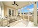 Enclosed outdoor patio features wicker furniture and large sliding glass doors offering backyard views at 422 Islebay Dr, Apollo Beach, FL 33572