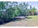 Tranquil backyard retreat with a wooden platform amidst lush greenery, creating a serene outdoor space at 510 55Th Ne Ave, St Petersburg, FL 33703