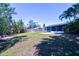 Expansive backyard featuring a wooden fence line and a concrete patio at 510 55Th Ne Ave, St Petersburg, FL 33703