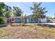 Charming single-story home featuring a manicured lawn and a quaint front yard with mature landscaping at 510 55Th Ne Ave, St Petersburg, FL 33703