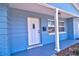 Close up of the covered front porch with blue trim and a white front door at 510 55Th Ne Ave, St Petersburg, FL 33703