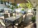 Entertain in style with a pool, lounge chairs, and outdoor dining surrounded by lush foliage at 5430 Avenida Del Mare, Sarasota, FL 34242