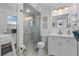 This bathroom offers a glass shower, modern fixtures, and storage in the sink and shelves at 5430 Avenida Del Mare, Sarasota, FL 34242
