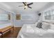 Bright bedroom with modern ceiling fan, wood floors, and large windows providing lots of natural light at 5430 Avenida Del Mare, Sarasota, FL 34242