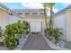 Inviting home entrance featuring a brick pathway, double doors, and well-maintained landscaping at 5430 Avenida Del Mare, Sarasota, FL 34242
