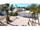 Charming single-story home featuring a brick driveway, two-car garage, and lush landscaping with palm trees at 5430 Avenida Del Mare, Sarasota, FL 34242
