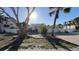 Attractive home exterior featuring palm trees, a two-car garage, and a well-manicured front yard at 5430 Avenida Del Mare, Sarasota, FL 34242