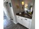 Hallway featuring cabinets and a countertop, decor, and a mirror that reflects the kitchen area at 5430 Avenida Del Mare, Sarasota, FL 34242