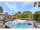 Exterior view of the hot tub, in a backyard setting with a pool, patio and luscious palms at 5430 Avenida Del Mare, Sarasota, FL 34242