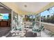 Relaxing lanai with comfortable seating, screened enclosure, and serene water views at 5430 Avenida Del Mare, Sarasota, FL 34242
