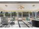Inviting screened lanai featuring comfortable seating and a view of the lush backyard at 5430 Avenida Del Mare, Sarasota, FL 34242