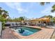 Refreshing backyard pool area featuring a brick patio, plenty of seating, and a built-in grill at 5430 Avenida Del Mare, Sarasota, FL 34242