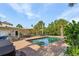 Inviting backyard pool surrounded by lush landscaping and various seating areas at 5430 Avenida Del Mare, Sarasota, FL 34242