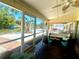 Screened-in porch with comfortable seating overlooking scenic waterfront at 5430 Avenida Del Mare, Sarasota, FL 34242