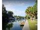 Scenic waterfront with a private dock, lush greenery, and clear blue skies for a perfect lifestyle at 5430 Avenida Del Mare, Sarasota, FL 34242
