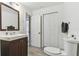Modern bathroom with a sink, toilet, and closet, offering convenience and storage at 5619 New York Ave, Sarasota, FL 34231