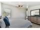 Bright bedroom featuring a comfortable bed, dresser with mirror, and natural light from a window at 5619 New York Ave, Sarasota, FL 34231