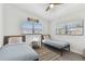 Cozy bedroom featuring two twin beds, wood-look floors, natural light from the windows, and light walls at 5619 New York Ave, Sarasota, FL 34231