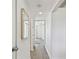 Hallway featuring wood floors and mirrors, leading to various rooms in the house at 5619 New York Ave, Sarasota, FL 34231