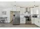 Modern kitchen features stainless steel appliances, white subway tile backsplash, and white cabinetry at 5619 New York Ave, Sarasota, FL 34231