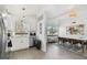 Open-concept kitchen with stainless steel appliances, white cabinets, and view into the dining area at 5619 New York Ave, Sarasota, FL 34231