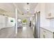 Bright, open-concept space with sleek gray floors, white cabinets, and stainless steel refrigerator at 5619 New York Ave, Sarasota, FL 34231