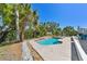 Outdoor patio with outdoor seating and lush landscaping, near a pool for outdoor relaxation at 5619 New York Ave, Sarasota, FL 34231