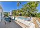 Outdoor patio with outdoor seating and lush landscaping, near a pool for outdoor relaxation at 5619 New York Ave, Sarasota, FL 34231