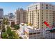 An aerial view captures the building's facade, balconies and rooftop pool with lounge area at 628 Cleveland St # 612, Clearwater, FL 33755