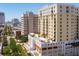 An aerial view captures the building's facade, balconies and rooftop pool with lounge area at 628 Cleveland St # 612, Clearwater, FL 33755