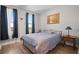 Cozy bedroom with warm wood floors, a comfortable bed, and natural light from the window at 628 Cleveland St # 612, Clearwater, FL 33755