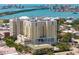 Aerial view of a condo building featuring a rooftop pool and beautiful waterfront views at 628 Cleveland St # 612, Clearwater, FL 33755