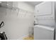Efficient laundry room with a stacked washer and dryer, with shelving above for storage solutions at 628 Cleveland St # 612, Clearwater, FL 33755
