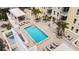 Breathtaking rooftop pool with clear blue water, sun loungers, and lush greenery, perfect for relaxation and recreation at 628 Cleveland St # 612, Clearwater, FL 33755