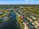 Breathtaking aerial view of a waterfront community with lush landscaping and serene waterside residences with boat docks at 6497 Cape Hatteras Ne Way # 3, St Petersburg, FL 33702