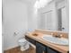 Well-lit bathroom with a large mirror and a classic vanity and toilet at 6497 Cape Hatteras Ne Way # 3, St Petersburg, FL 33702