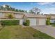 Charming townhome with attached garage, well-maintained lawn, and lush landscaping at 6497 Cape Hatteras Ne Way # 3, St Petersburg, FL 33702