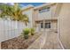 A cozy outdoor patio with a gravel floor, potted plants and a white privacy fence at 6497 Cape Hatteras Ne Way # 3, St Petersburg, FL 33702