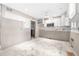 A partially renovated kitchen shows a microwave, a ceiling fan and white cabinets at 6497 Cape Hatteras Ne Way # 3, St Petersburg, FL 33702